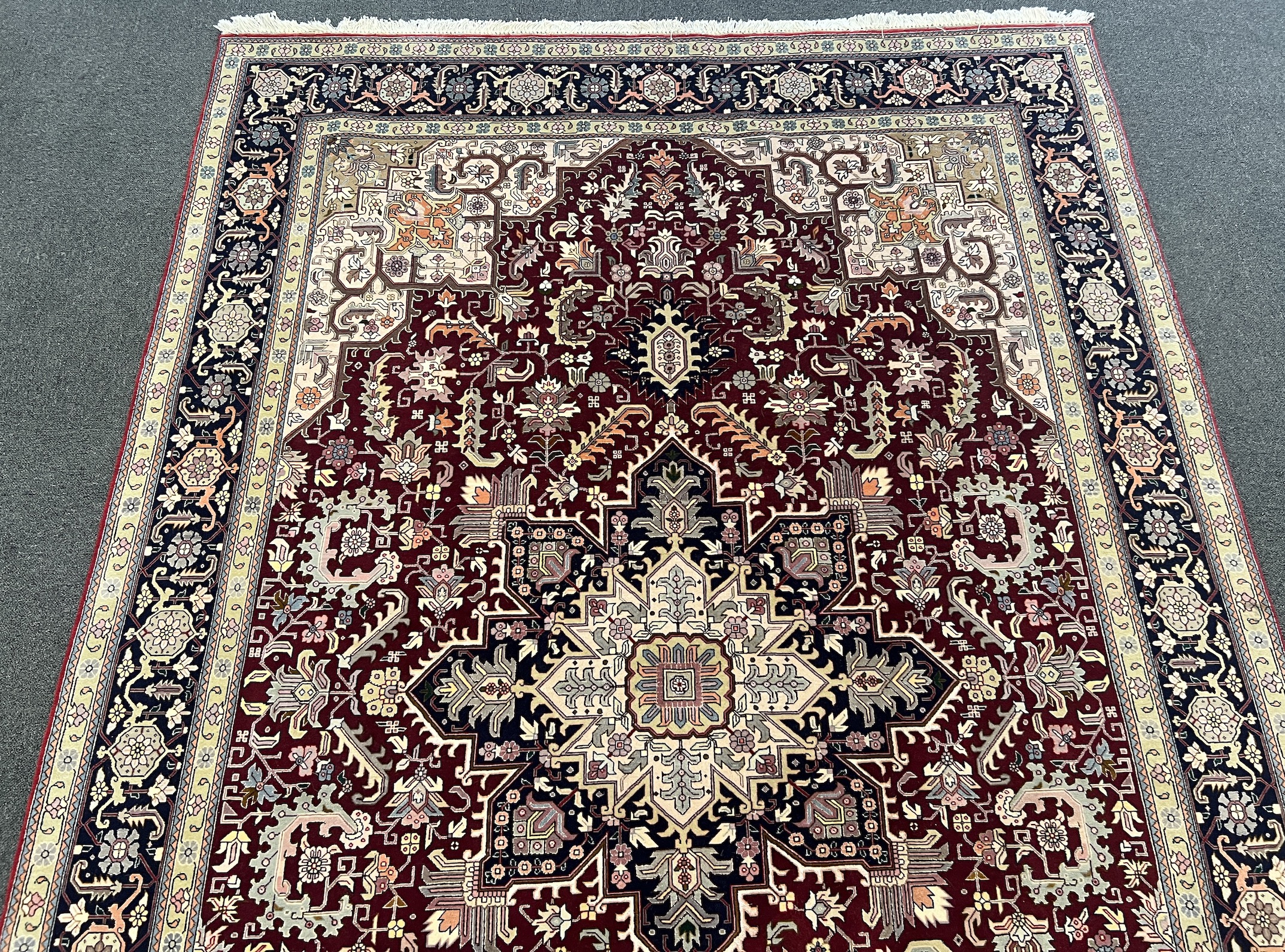 A Tabriz part silk burgundy ground carpet